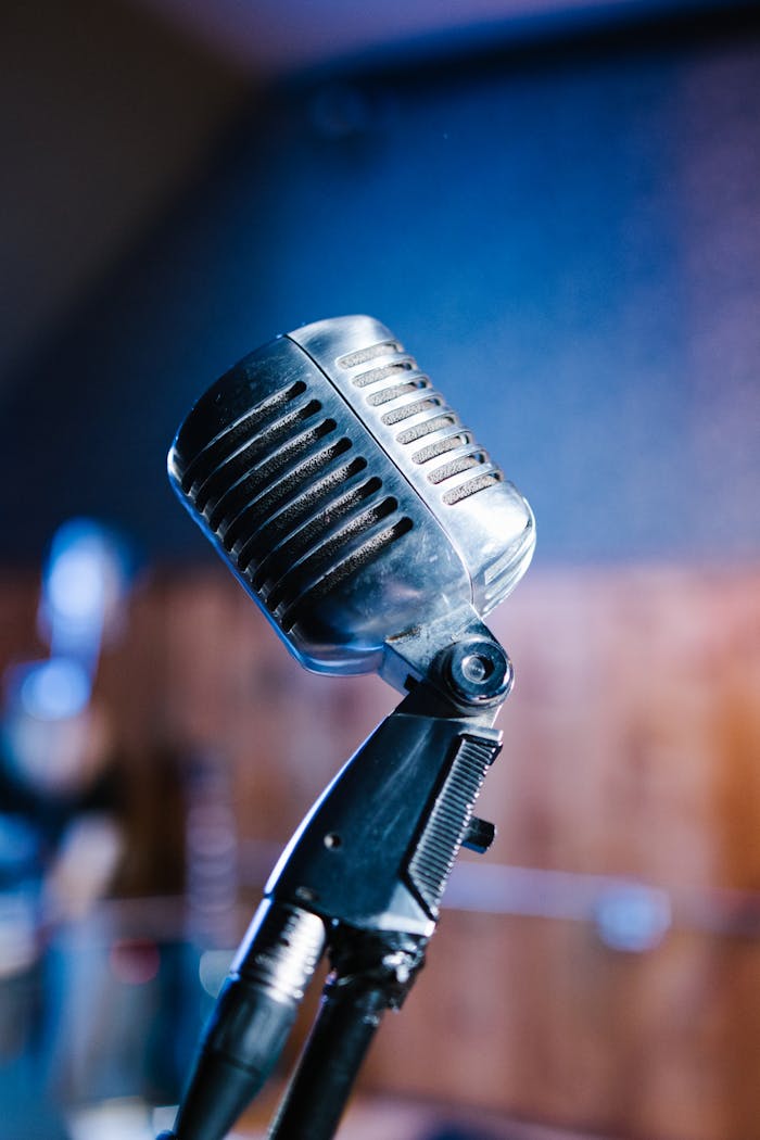 Close-up of a vintage microphone in a studio with blurred background.